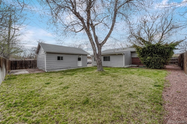 view of yard featuring a fenced backyard and an outdoor structure