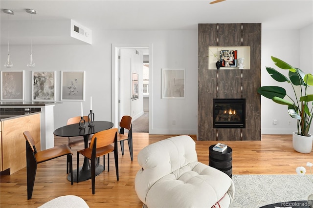 340 S Lafayette St Unit 201, Denver, CO 80209 - dining room with light wood-style flooring, baseboards, and a fireplace