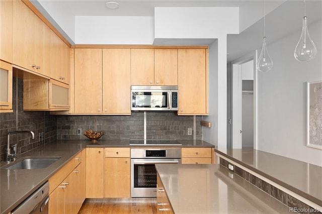 340 S Lafayette St Unit 201, Denver, CO 80209 - kitchen featuring stainless steel appliances, a sink, decorative backsplash, and light brown cabinetry
