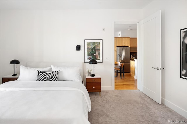 340 S Lafayette St Unit 201, Denver, CO 80209 - bedroom with stainless steel fridge with ice dispenser, carpet, and baseboards