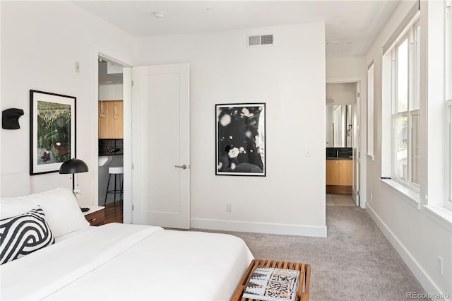 340 S Lafayette St Unit 201, Denver, CO 80209 - bedroom featuring multiple windows, carpet flooring, baseboards, and connected bathroom