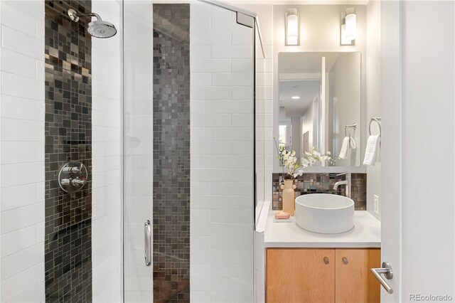 340 S Lafayette St Unit 201, Denver, CO 80209 - full bath with a stall shower, vanity, and decorative backsplash