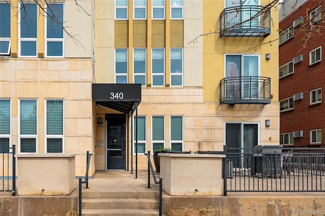 340 S Lafayette St Unit 201, Denver, CO 80209 - view of property featuring a wall mounted air conditioner and fence