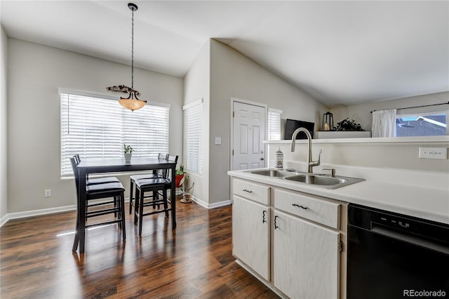 kitchen featuring dishwasher, lofted ceiling, sink, dark hardwood / wood-style flooring, and hanging light fixtures