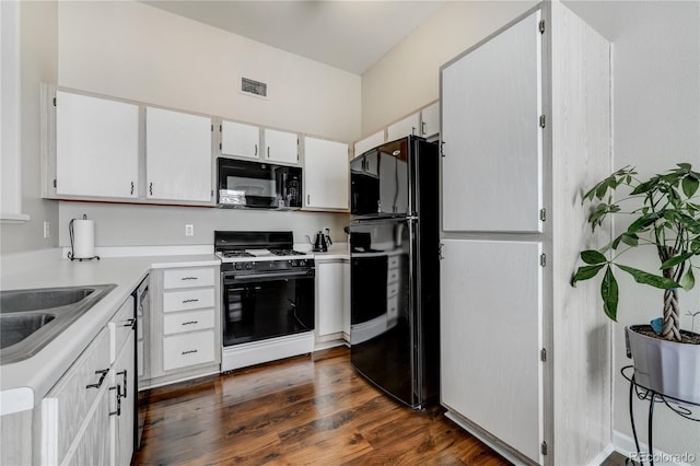 kitchen featuring dark hardwood / wood-style floors, sink, white cabinets, and black appliances