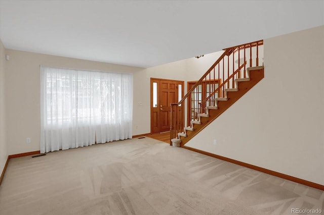 unfurnished living room featuring carpet floors