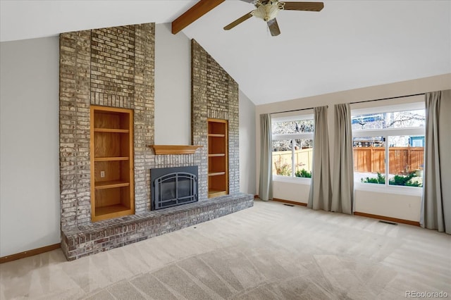 unfurnished living room featuring a brick fireplace, light colored carpet, built in features, and beam ceiling