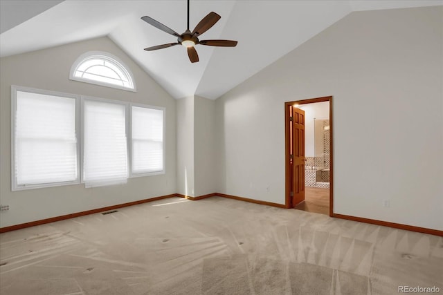 unfurnished room featuring ceiling fan, light colored carpet, and vaulted ceiling