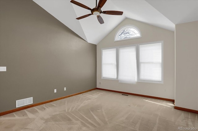 carpeted spare room featuring ceiling fan and vaulted ceiling