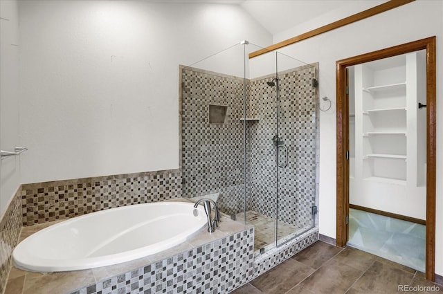 bathroom featuring plus walk in shower, tile patterned floors, built in features, and lofted ceiling