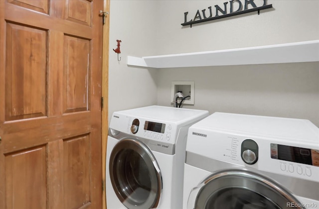 clothes washing area featuring separate washer and dryer