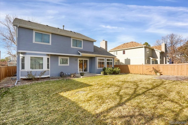 back of house featuring a lawn