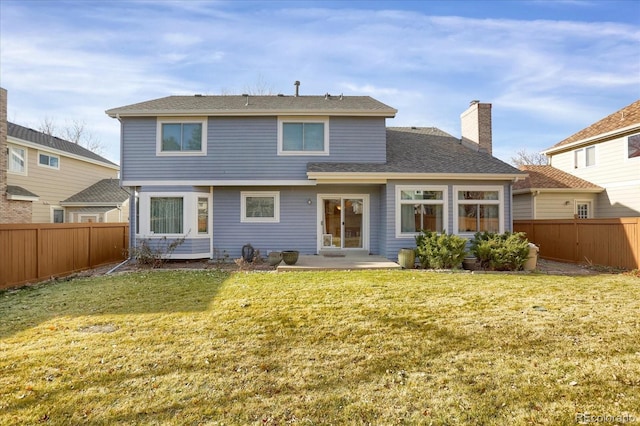 back of house with a patio area and a yard