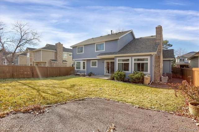 rear view of property featuring a yard