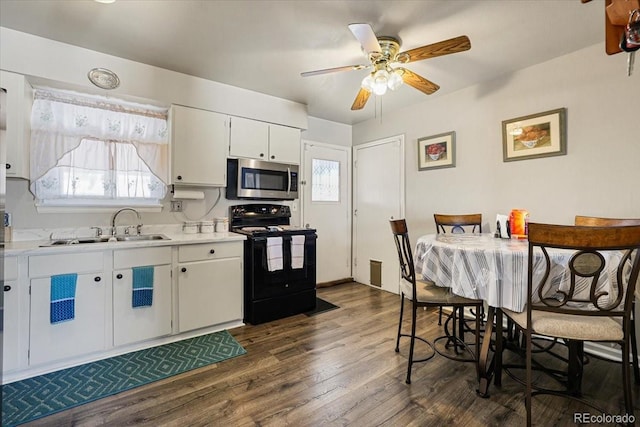 kitchen featuring sink, ceiling fan, black range with electric stovetop, dark hardwood / wood-style floors, and white cabinets