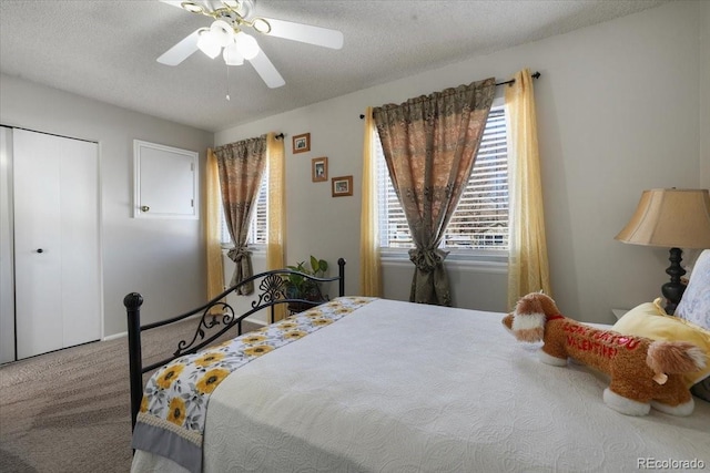 bedroom with ceiling fan, a closet, carpet floors, and a textured ceiling