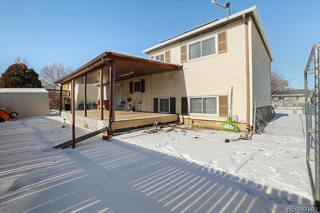 snow covered property with a wooden deck