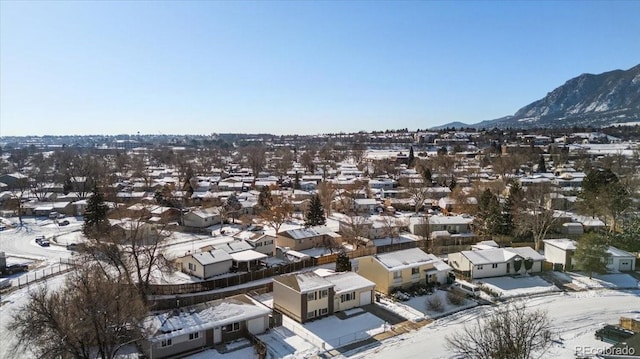 snowy aerial view featuring a mountain view