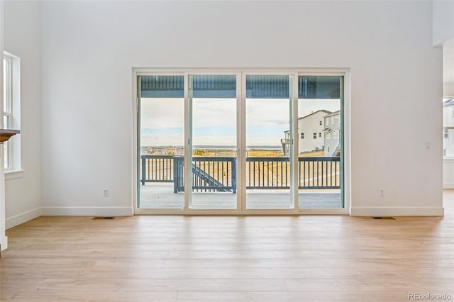 9322 Quaker St, Arvada, CO 80007 - spare room featuring light wood finished floors, baseboards, and visible vents