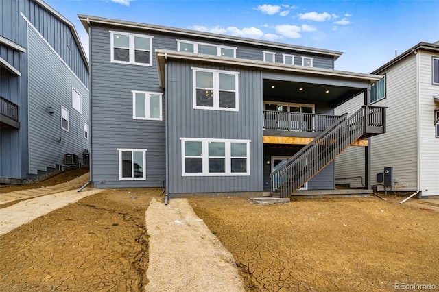9322 Quaker St, Arvada, CO 80007 - back of property with central air condition unit, board and batten siding, and stairway