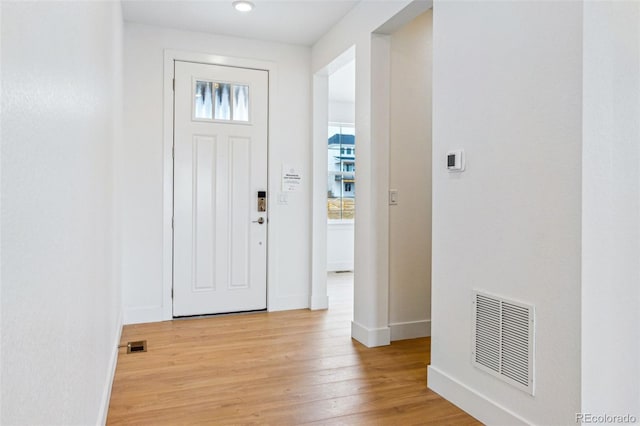 9322 Quaker St, Arvada, CO 80007 - foyer featuring light wood finished floors, baseboards, and visible vents