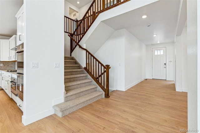 9322 Quaker St, Arvada, CO 80007 - foyer with stairs, light wood-style floors, and baseboards
