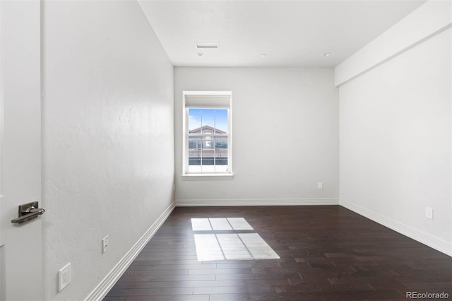 spare room with dark hardwood / wood-style floors