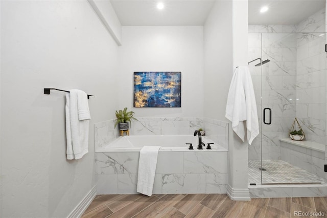 bathroom with shower with separate bathtub and hardwood / wood-style floors