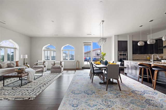 dining area with a notable chandelier and dark hardwood / wood-style floors