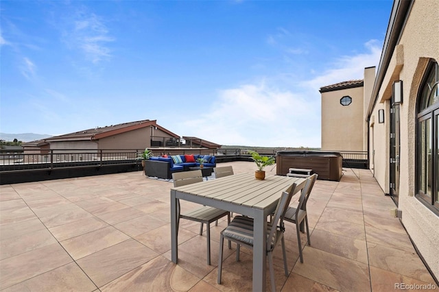 view of patio / terrace featuring an outdoor living space and a hot tub