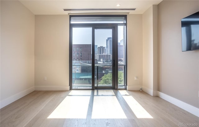 spare room featuring light hardwood / wood-style flooring