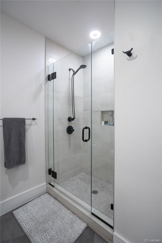 bathroom featuring walk in shower and tile floors