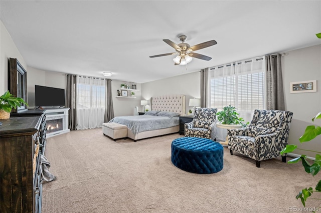 carpeted bedroom with multiple windows and ceiling fan