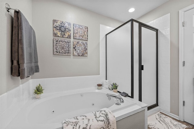 bathroom featuring separate shower and tub