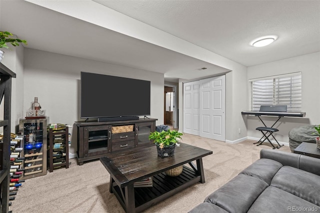 carpeted living room featuring a textured ceiling