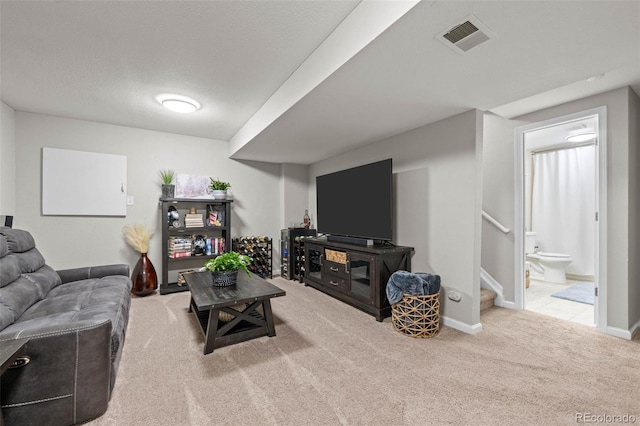 carpeted living room with a textured ceiling