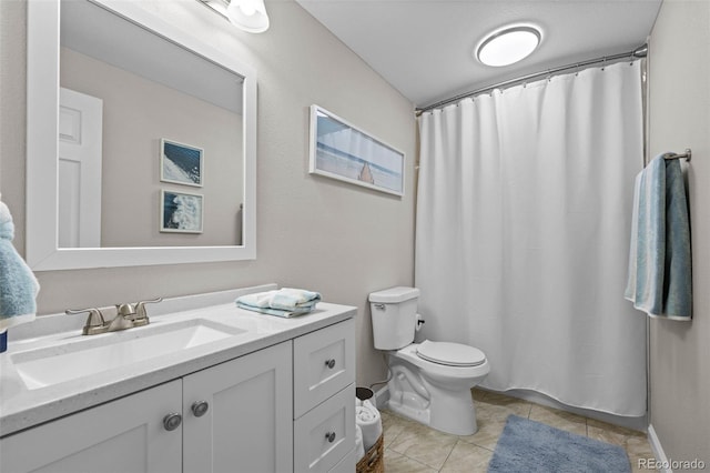 bathroom featuring tile patterned floors, vanity, and toilet