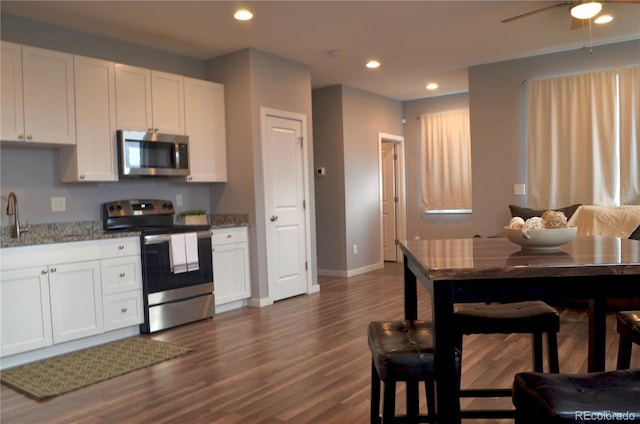 kitchen featuring white cabinets, appliances with stainless steel finishes, and light stone countertops