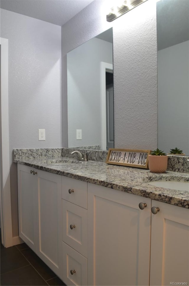 bathroom with tile patterned flooring and vanity