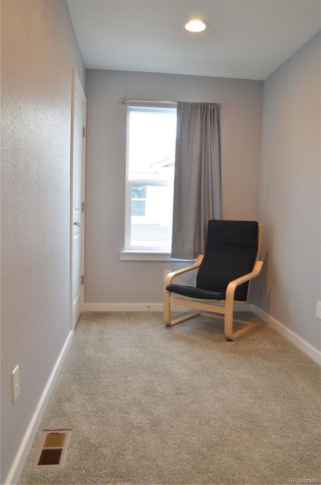 living area with light colored carpet