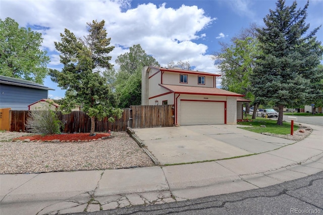 7552 Garland St, Arvada, CO 80005 - traditional home with an attached garage, fence, and driveway