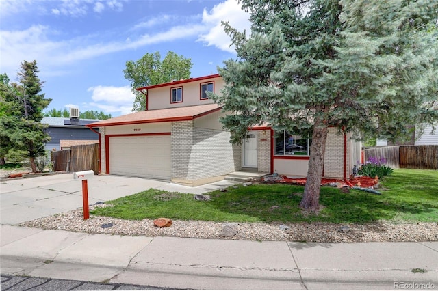 7552 Garland St, Arvada, CO 80005 - view of front of home with an attached garage, concrete driveway, and brick siding