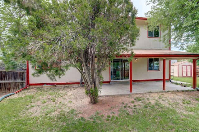 7552 Garland St, Arvada, CO 80005 - back of house featuring a patio, a storage shed, fence, and an outdoor structure