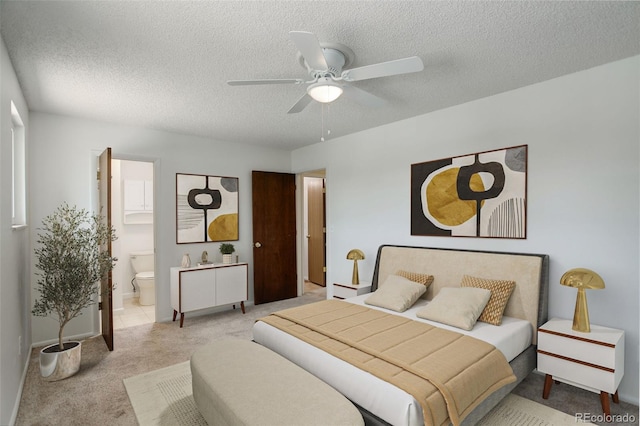 7552 Garland St, Arvada, CO 80005 - carpeted bedroom with a textured ceiling, ensuite bath, a ceiling fan, and baseboards