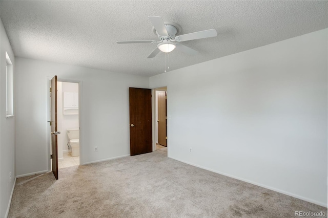 7552 Garland St, Arvada, CO 80005 - unfurnished bedroom featuring light colored carpet, a textured ceiling, baseboards, connected bathroom, and ceiling fan