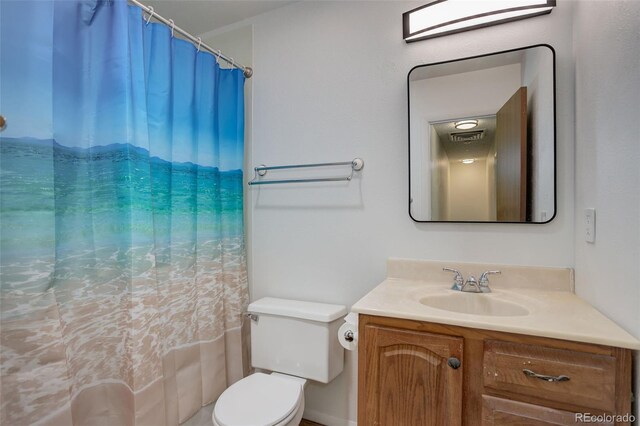 7552 Garland St, Arvada, CO 80005 - bathroom featuring vanity, toilet, and curtained shower