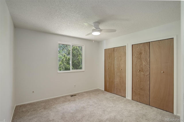 7552 Garland St, Arvada, CO 80005 - unfurnished bedroom featuring two closets, carpet floors, a textured ceiling, and baseboards