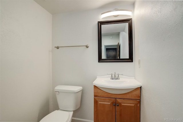 7552 Garland St, Arvada, CO 80005 - half bath featuring vanity, toilet, and baseboards