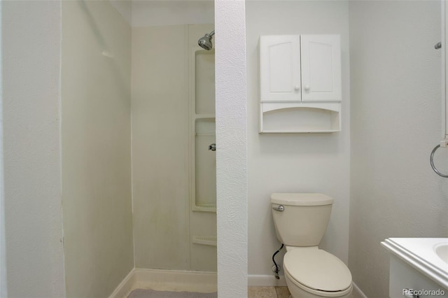 7552 Garland St, Arvada, CO 80005 - full bathroom with baseboards, toilet, vanity, and a shower