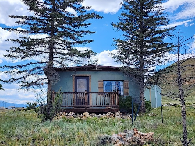 view of front of home featuring a deck with mountain view